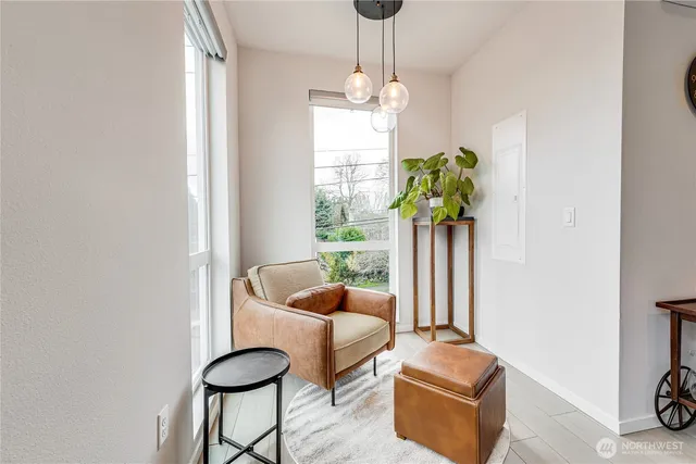 a living room with furniture and a chandelier