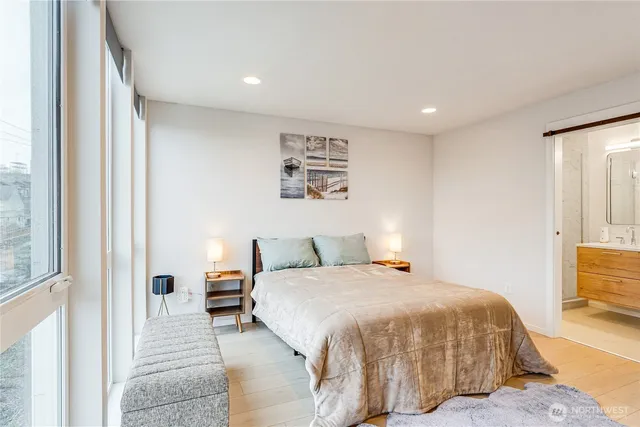 a bedroom with a bed and wooden floor