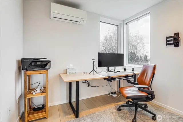 a view of a workspace with furniture and a window