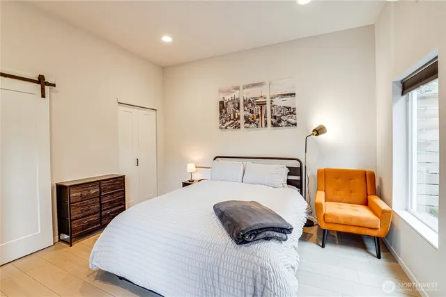 a bedroom with a bed couch and a window