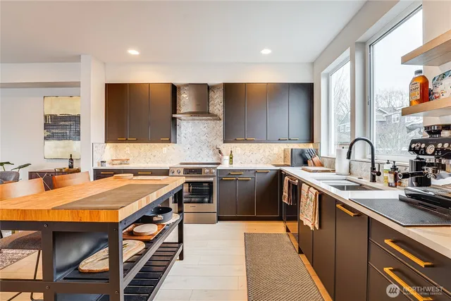 a kitchen with stainless steel appliances granite countertop a sink stove and refrigerator