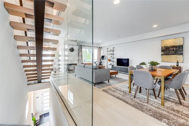 a living room with furniture a flat screen tv and a table