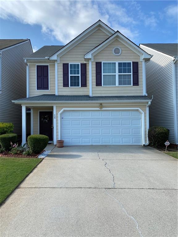 195 Crestfield Circle Covington, GA 30016 - Photo 1 of 1 a front view of a house with a yard and garage