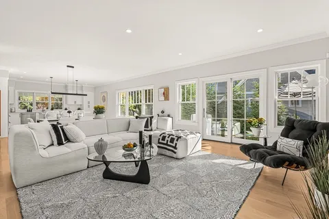 a living room with furniture and floor to ceiling windows
