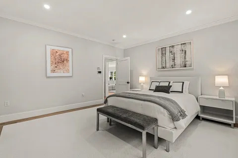 a spacious bedroom with a bed and wall painting