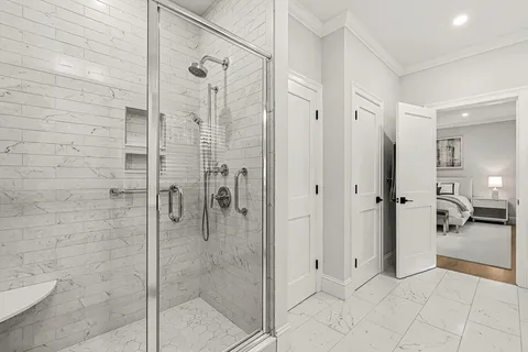 a bathroom with a glass shower door