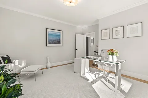 a view of a workspace with furniture and wooden floor