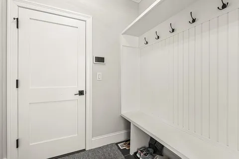 a room with a white wall and a white cabinet