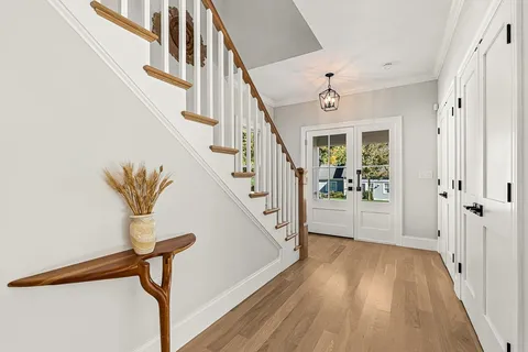 a view of entryway and hall with wooden floor