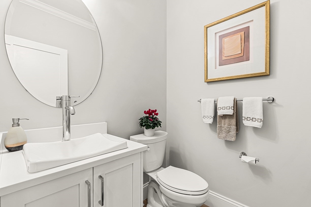 5 Peakes Lane, Unit 5 Weston, MA 02493 - Photo 21 of 32 a bathroom with a sink mirror vanity and toilet