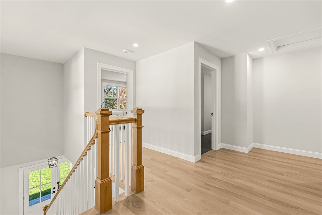 5 Peakes Lane, Unit 5 Weston, MA 02493 - Photo 22 of 32 a view of a hallway with wooden floor and staircase