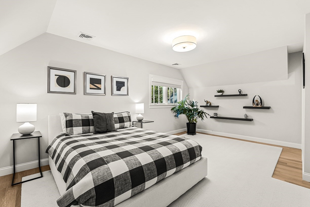 5 Peakes Lane, Unit 5 Weston, MA 02493 - Photo 23 of 32 a bedroom with a bed and wooden floor