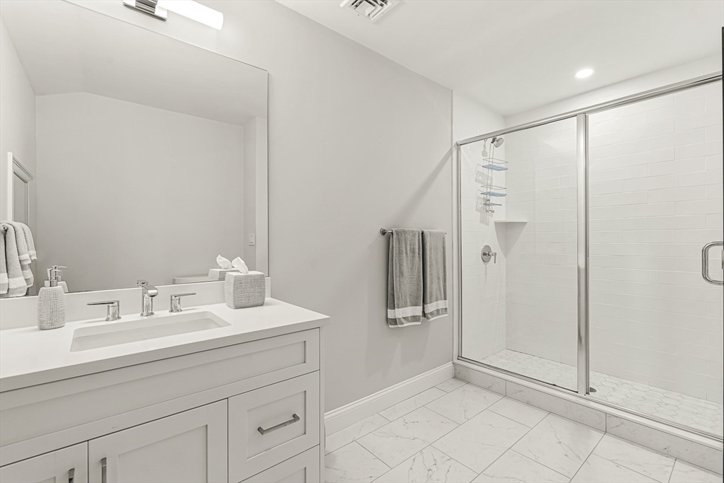 5 Peakes Lane, Unit 5 Weston, MA 02493 - Photo 25 of 32 a bathroom with a sink and a mirror