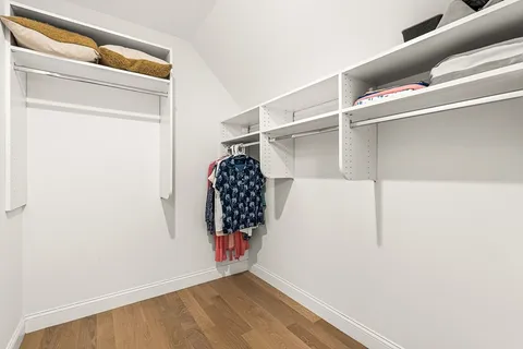 a view of walk in closet with clothes