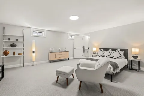 a spacious bedroom with a bed and a couch