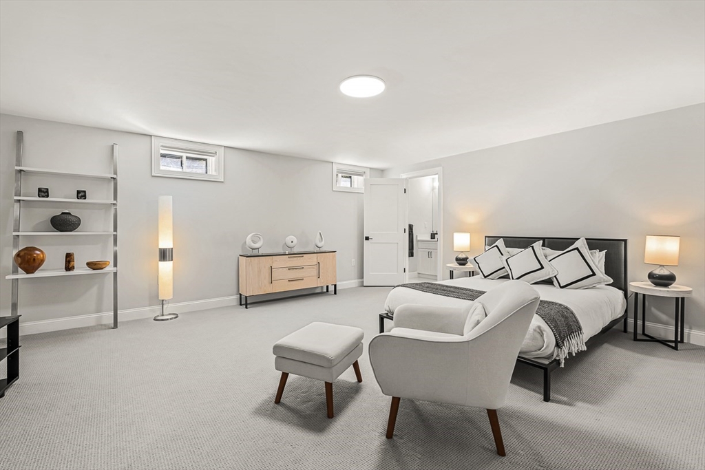 5 Peakes Lane, Unit 5 Weston, MA 02493 - Photo 29 of 32 a spacious bedroom with a bed and a couch