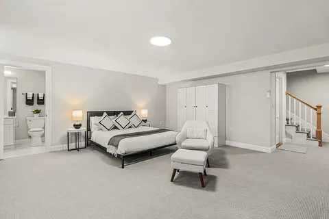 a spacious bedroom with a bed and a couch