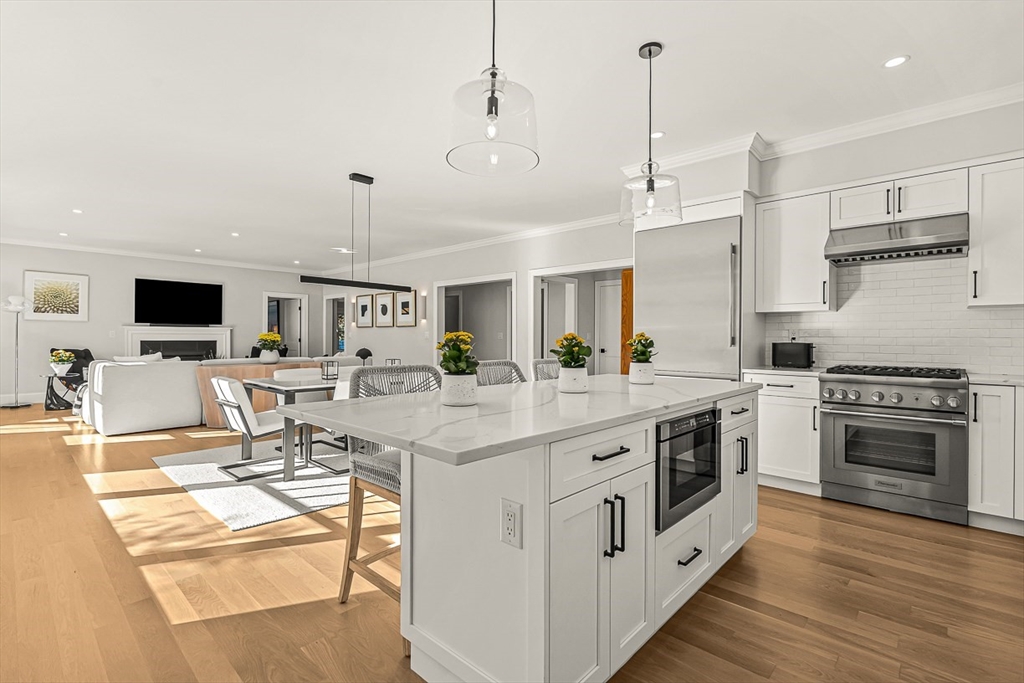 5 Peakes Lane, Unit 5 Weston, MA 02493 - Photo 6 of 32 a kitchen with stainless steel appliances kitchen island granite countertop a sink and cabinets