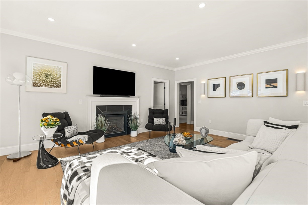 5 Peakes Lane, Unit 5 Weston, MA 02493 - Photo 10 of 32 a living room with furniture a fireplace and a flat screen tv