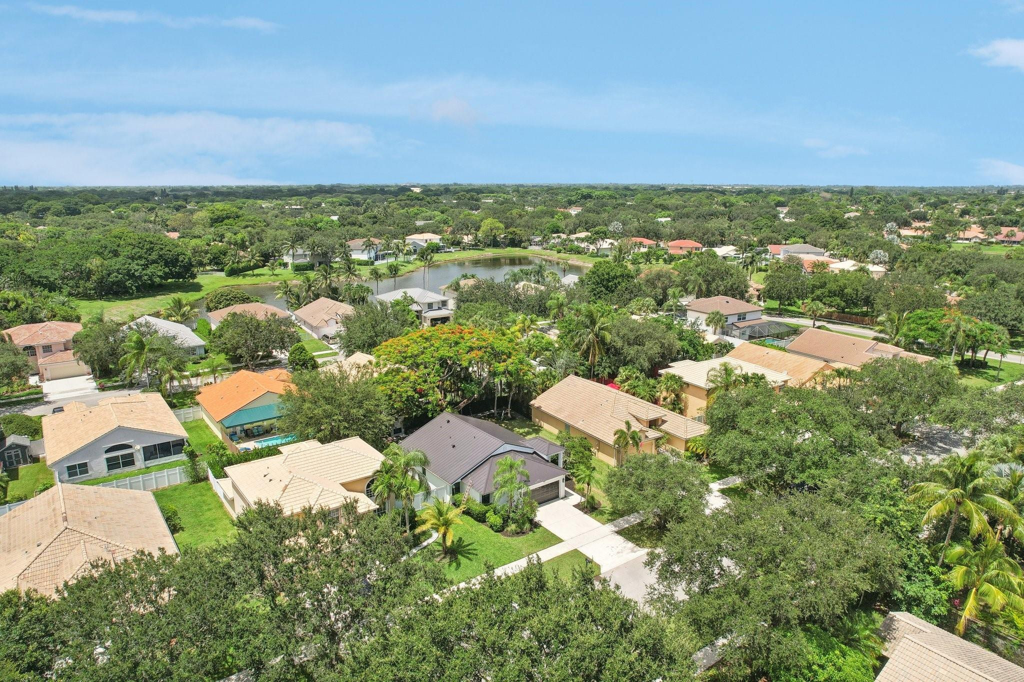 4035 Sabal Lakes Road Delray Beach, FL 33445 - Photo 38 of 43 an aerial view of residential houses with outdoor space and trees