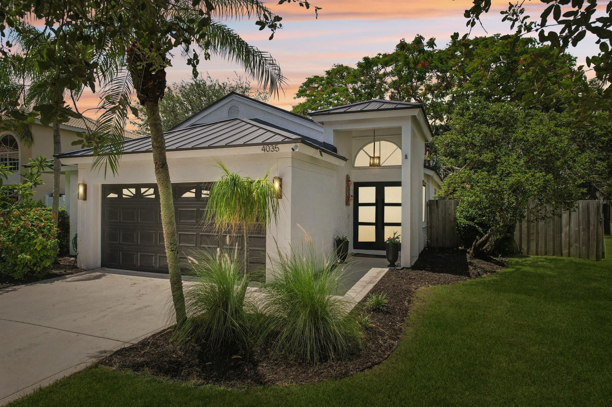 4035 Sabal Lakes Road Delray Beach, FL 33445 - Photo 42 of 43 a front view of a house with garden