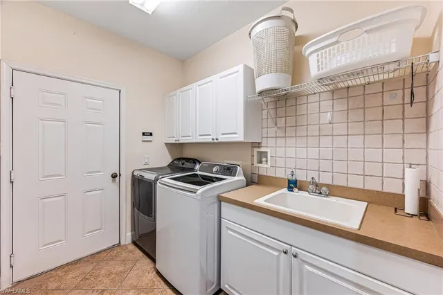 a room with a sink and cabinets