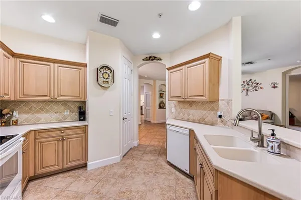 a spacious bathroom with a sink and a mirror