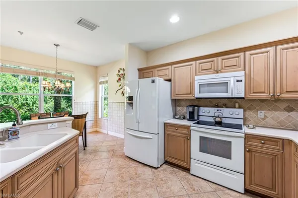 a kitchen with a stove a sink and a refrigerator