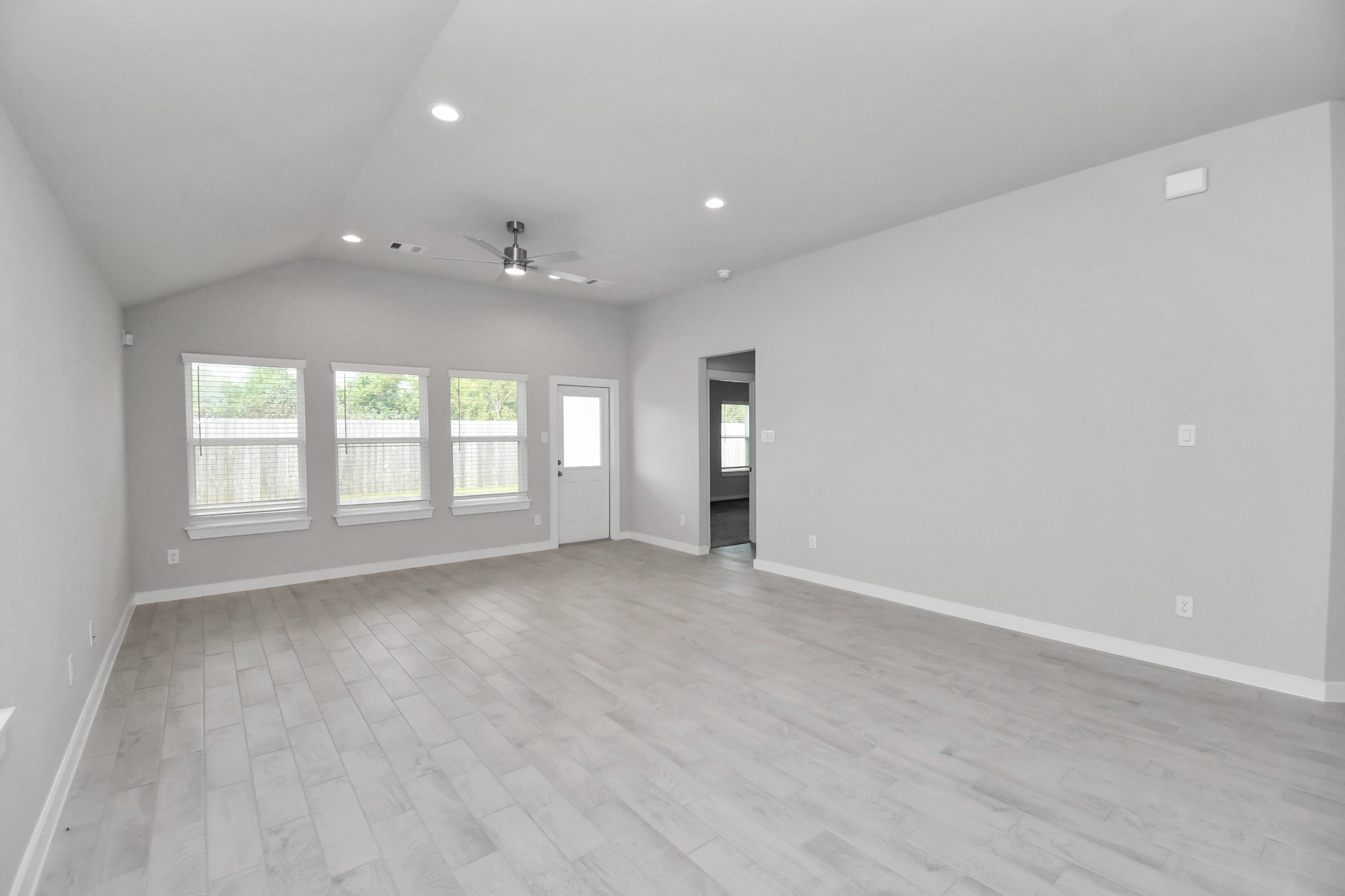 24611 Broad Park Spring, TX 77373 - Photo 12 of 25 Welcome family and guests to your charming living room! With its high ceilings, recessed lighting, ceiling fan, custom paint, beautiful flooring, and large windows that let in abundant natural light, this room is perfect for gatherings. Sample photo of completed home with similar floor plan. Actual colors and selections may vary.