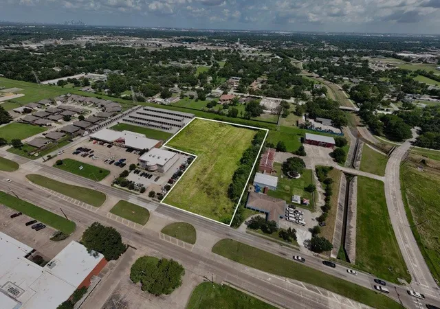 an aerial view of a residential houses with outdoor space