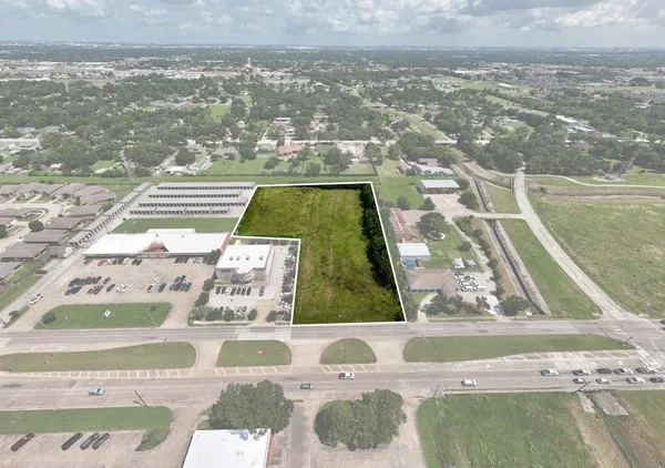 an aerial view of a house with a garden and swimming pool