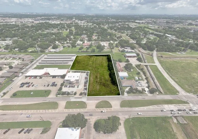 an aerial view of a house with a garden and swimming pool