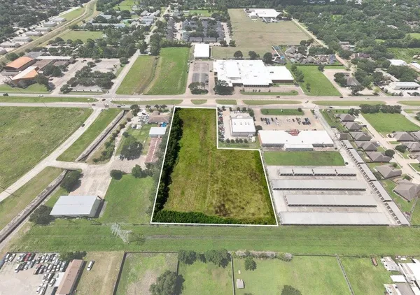 an aerial view of a pool lawn chairs and a fire pit