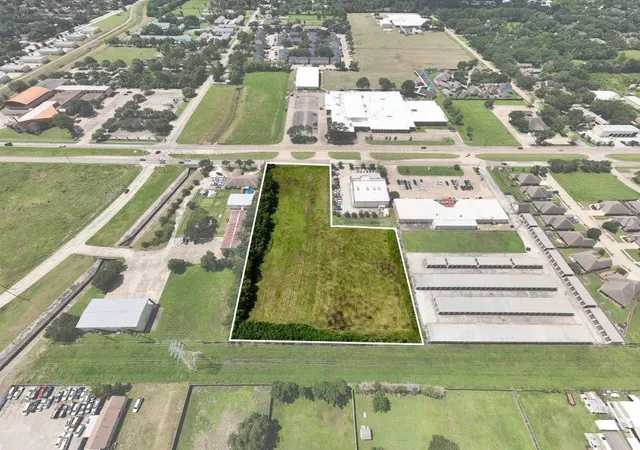 an aerial view of a pool lawn chairs and a fire pit