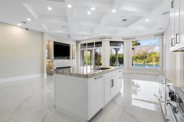 a kitchen with stainless steel appliances granite countertop a stove and a wooden floors