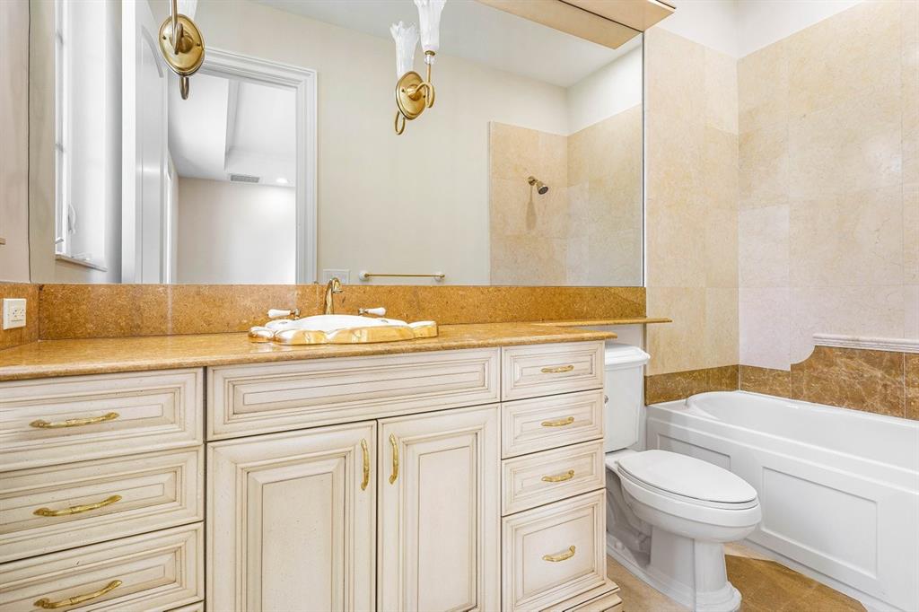 549 Northeast 19th Avenue, Unit C Deerfield Beach, FL 33441 - Photo 37 of 79 a bathroom with a granite countertop toilet sink and a bathtub