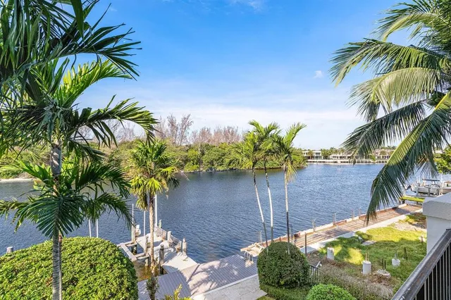 an aerial view of a house with swimming pool and outdoor seating