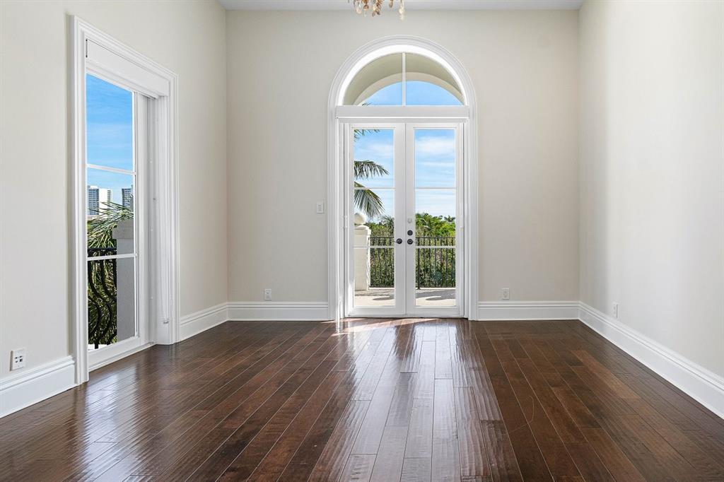549 Northeast 19th Avenue, Unit C Deerfield Beach, FL 33441 - Photo 39 of 79 a view of an empty room with wooden floor and a window