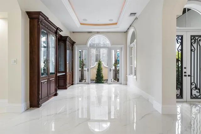a living room with furniture kitchen and a large window