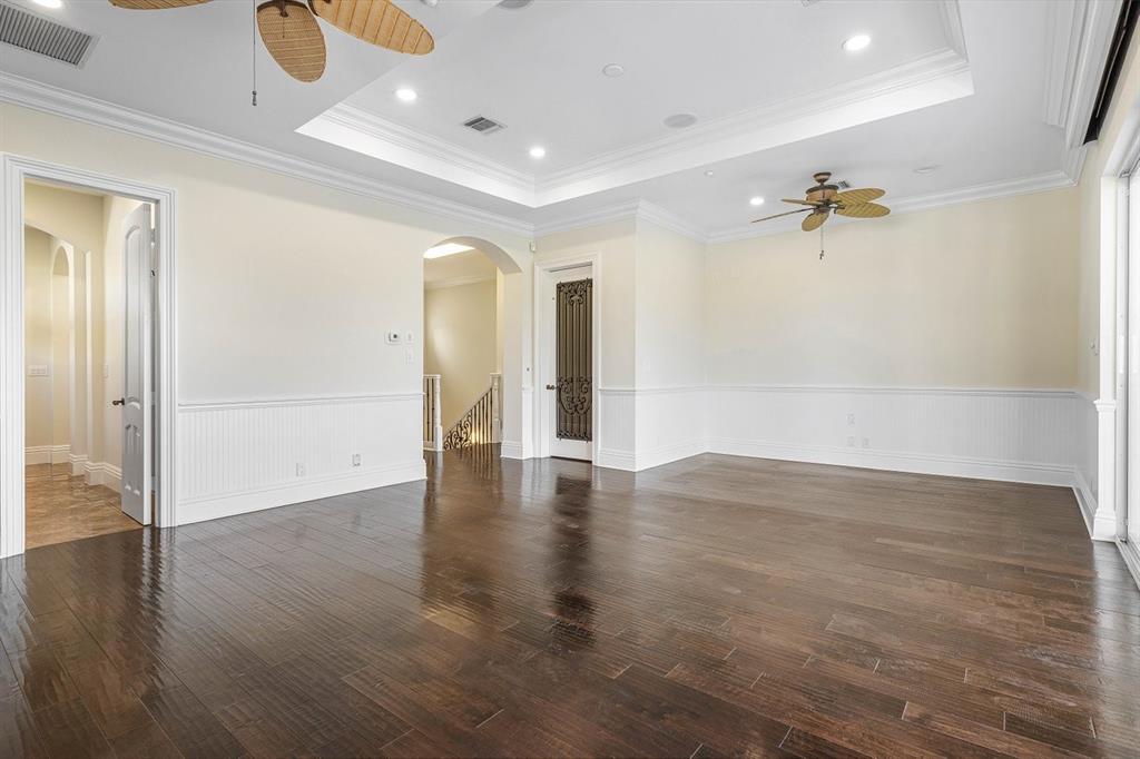 549 Northeast 19th Avenue, Unit C Deerfield Beach, FL 33441 - Photo 45 of 79 an empty room with wooden floor and a ceiling fan