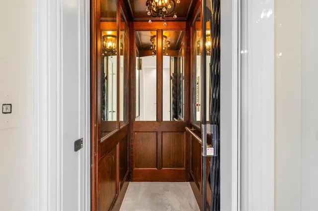 a view of a lake from a balcony with seating space