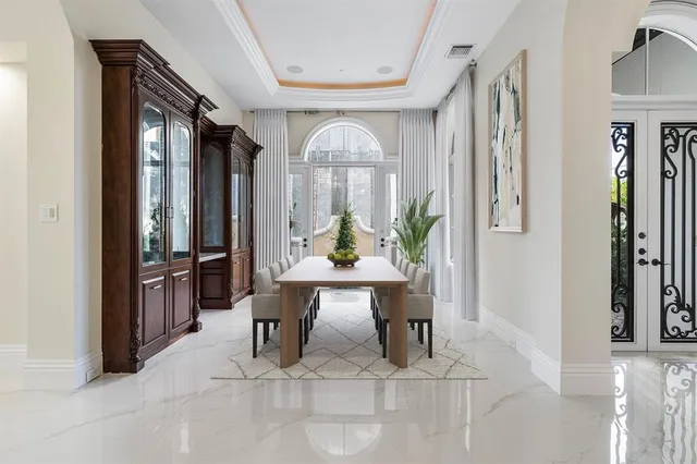 a large white kitchen with a large window and stainless steel appliances