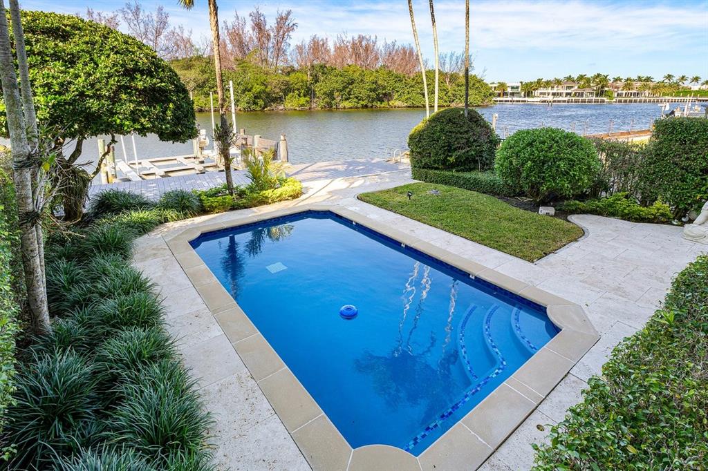 549 Northeast 19th Avenue, Unit C Deerfield Beach, FL 33441 - Photo 53 of 79 a view of a swimming pool with a lake and a garden