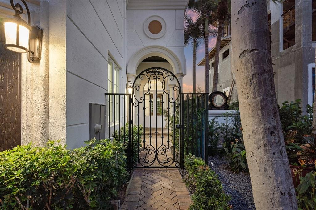 549 Northeast 19th Avenue, Unit C Deerfield Beach, FL 33441 - Photo 69 of 79 a view of a brick house with a flower garden