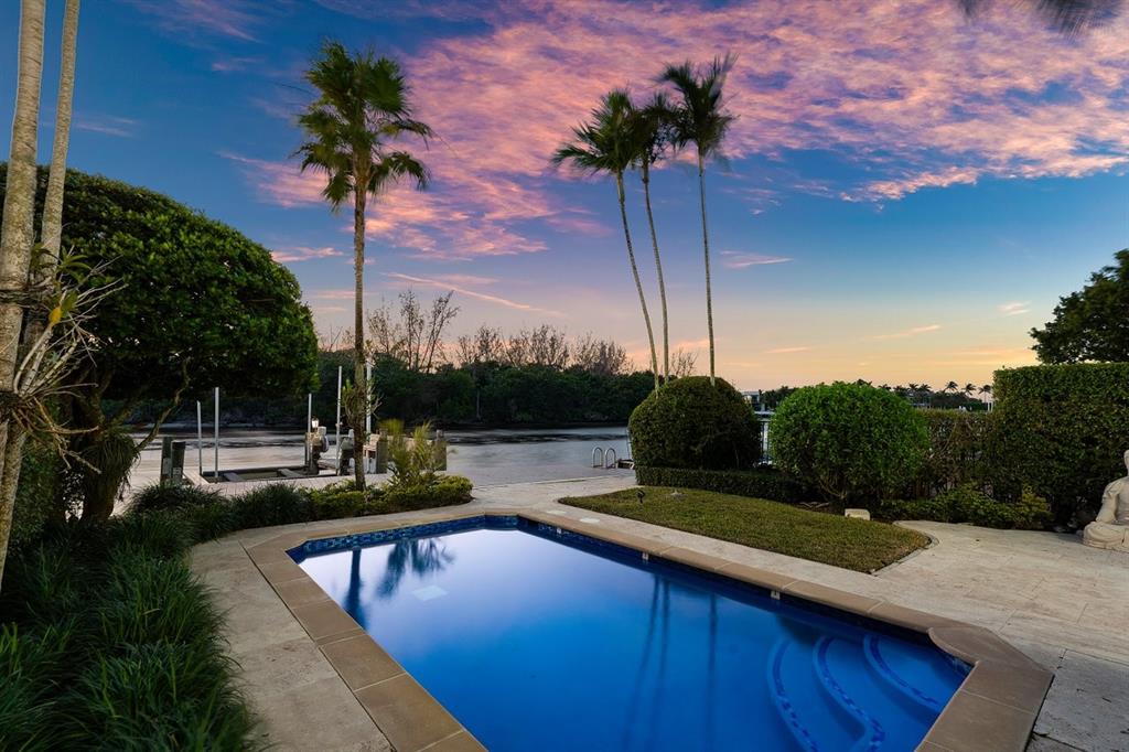 549 Northeast 19th Avenue, Unit C Deerfield Beach, FL 33441 - Photo 75 of 79 a view of a swimming pool with a table and chairs