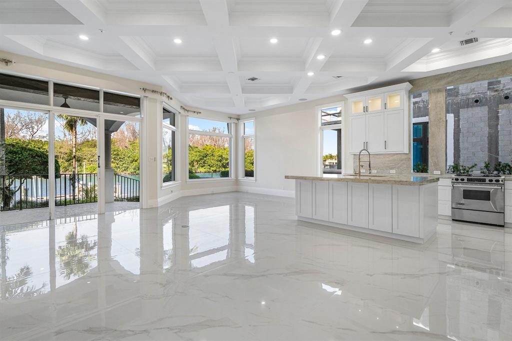 549 Northeast 19th Avenue, Unit C Deerfield Beach, FL 33441 - Photo 10 of 79 a large white kitchen with a large window and stainless steel appliances