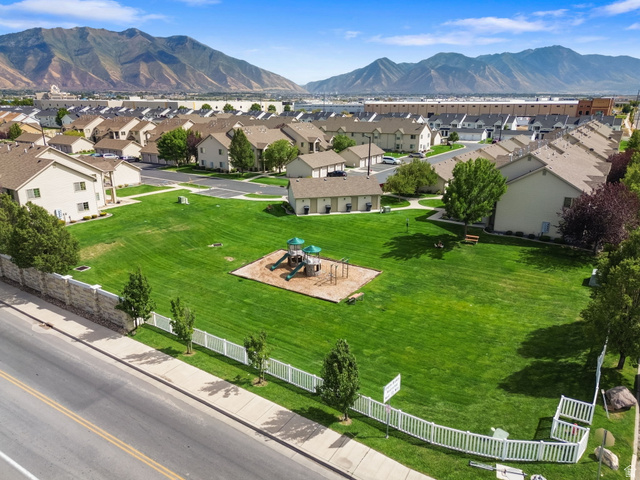 482 South 2500th West, Unit 2 Springville, UT 84663 - Photo 42 of 52 Expansive green space featuring a playground structure and surrounding residential properties