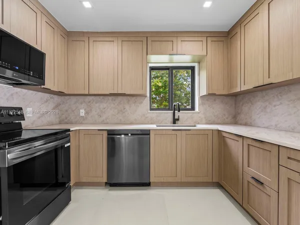 a kitchen with a sink stove and microwave