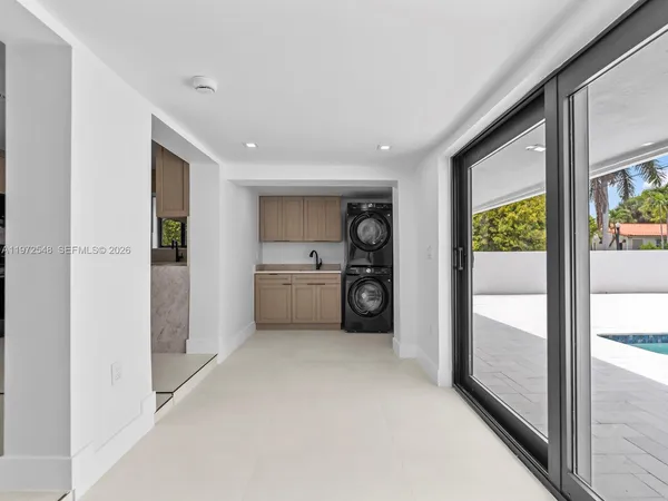 a view of a hallway with bathroom and mirror