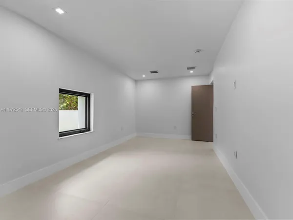 an empty room with a empty space and windows